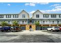 Exterior view of townhomes with parking and a courtyard at 720 Celebration Ave # 220, Celebration, FL 34747