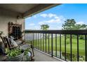 Balcony with comfortable seating and a view of the lake at 1052 Lotus Cove Ct # 743, Altamonte Springs, FL 32714