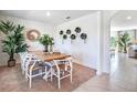 Modern dining room featuring a light wood table and white chairs at 7137 Painted Bunting Way, Saint Cloud, FL 34773