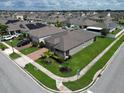 Aerial view of a single-Gathering home in a residential neighborhood with a large yard and brick driveway at 4762 Riverwalk Dr, Saint Cloud, FL 34771