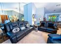 Bright living room with leather sofas and a mirrored wall creating an open feel at 1001 Eva St, Deltona, FL 32725