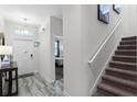 Entryway with tile floor, stairs, and view into bedroom at 1638 Moon Valley Dr, Davenport, FL 33896