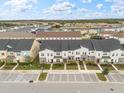 Aerial view of townhomes with parking and surrounding neighborhood at 2163 Copper Bell Pl, Kissimmee, FL 34747