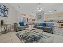 Bright living room features two gray sofas, a coffee table, and a decorative rug at 8151 Canyon Lake Cir, Orlando, FL 32835