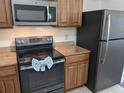 Updated kitchen with granite countertops and stainless steel appliances at 12527 Floridays Resort Dr # 510E, Orlando, FL 32821
