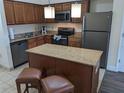 Modern kitchen with granite countertops and stainless steel appliances at 12527 Floridays Resort Dr # 510E, Orlando, FL 32821