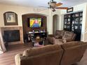 Gathering room with fireplace, built-in shelving and comfortable seating at 3635 Daydream Pl, Saint Cloud, FL 34772