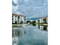 Serene lake view with fountains and residential buildings at 2717 Maitland Crossing Way # 207, Orlando, FL 32810