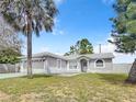 One-story home with gray exterior, two-car garage, and fenced yard at 15901 Greater Groves Blvd, Clermont, FL 34714