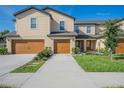 Two-story townhome with double garage and landscaping at 1714 Wynford Cir, Tavares, FL 32778
