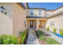 Front entry of townhome with walkway and landscaping at 1714 Wynford Cir, Tavares, FL 32778