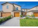Two-story townhome with double garage and walkway at 1714 Wynford Cir, Tavares, FL 32778