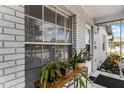 Inviting front porch with brick facade and potted plants at 142 Avenue F Sw, Winter Haven, FL 33880