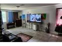 Spacious living room featuring a large TV and comfortable seating at 1149 Holden Ave, Orlando, FL 32839
