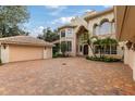 Brick driveway and two-car garage at 9164 Point Cypress Dr, Orlando, FL 32836