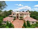 Grand estate home with tile roof and courtyard at 9164 Point Cypress Dr, Orlando, FL 32836