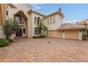 Brick driveway leading to a large home entrance at 9164 Point Cypress Dr, Orlando, FL 32836
