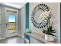 Bright entryway with modern console table and mirror at 1695 Southfork Dr, Kissimmee, FL 34744