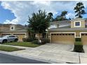 Two-story townhome with double garage and neatly landscaped yard at 452 Harbor Winds Ct, Winter Springs, FL 32708