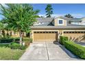 Two-story townhome with a two car garage and manicured lawn at 452 Harbor Winds Ct, Winter Springs, FL 32708