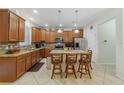 Spacious kitchen with island, stainless steel appliances, and wood cabinets at 3349 Rodrick Cir, Orlando, FL 32824