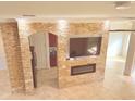 Living room featuring a stone fireplace and built-in entertainment center at 2877 Eastham Ln, Kissimmee, FL 34741