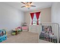 bedroom with crib, toys, and ample closet space at 1785 Ne 50Th Terrace, Ocala, FL 34470