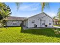 White brick home with a well-maintained lawn at 148 Merida Dr, Kissimmee, FL 34743