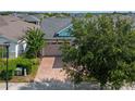 Aerial view of a house with a driveway and landscaping at 4907 W Fountainwood Dr, St Cloud, FL 34772
