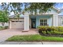 Light blue house with a front porch and two-car garage at 4907 W Fountainwood Dr, St Cloud, FL 34772