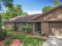 Brick and wood exterior with attached garage at 1469 Grace Lake Cir, Longwood, FL 32750