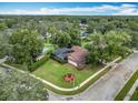Aerial view of a house with a pool and lush green landscaping at 1469 Grace Lake Cir, Longwood, FL 32750