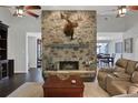 Spacious living room featuring a stone fireplace and hardwood floors at 700 Bear Shadow Ct, Longwood, FL 32779