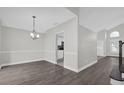 Bright dining area with gray vinyl flooring and a view into the kitchen at 10957 Norcross Cir, Orlando, FL 32825