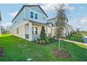 Two-story light blue home with a front porch and landscaping at 11944 Bracco St, Winter Garden, FL 34787