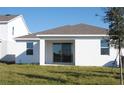 Rear view of a new single-story home with covered patio at 14569 Crestavista Dr, Clermont, FL 34714