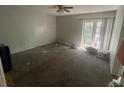 Spacious living room with carpet flooring and access to a patio at 2391 Moonstone Ave, Deltona, FL 32738