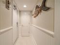 Bright hallway with white walls and wood-look floors at 5303 S Atlantic Ave # 35, New Smyrna Beach, FL 32169
