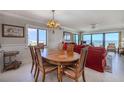 Ocean view dining room with wood table and red chairs at 5303 S Atlantic Ave # 35, New Smyrna Beach, FL 32169