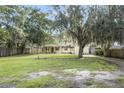 House with a large grassy front yard and mature trees at 5625 Chipola Cir, Orlando, FL 32839