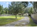 House with a large grassy front yard and mature trees at 5625 Chipola Cir, Orlando, FL 32839