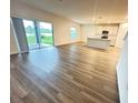 Spacious living room with kitchen and sliding glass doors leading to backyard at 420 Quarry Rock Cir, Kissimmee, FL 34758