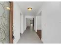 Bright entryway with gray tile floor and view to living room at 7904 Dunstable Cir, Orlando, FL 32817