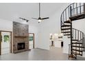 Living room with spiral staircase, fireplace and high ceilings at 7904 Dunstable Cir, Orlando, FL 32817