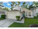 Two-story house with a two-car garage and manicured lawn at 812 Shell Ln, Longwood, FL 32750