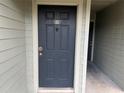 Condo building entry with dark door and light walls at 6088 Westgate Dr # 203, Orlando, FL 32835