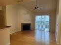 Bright living room with hardwood floors, fireplace, and sliding doors at 6088 Westgate Dr # 203, Orlando, FL 32835