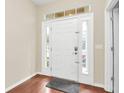 White front door with sidelights in a light-colored home at 655 Pensacola Ln, Lake Mary, FL 32746
