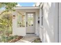 Inviting front entrance with a light taupe door and a sunroom at 1111 Chichester St, Orlando, FL 32803