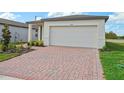 Single story home with a brick driveway and landscaping at 3653 Portsmouth Ln, Haines City, FL 33844